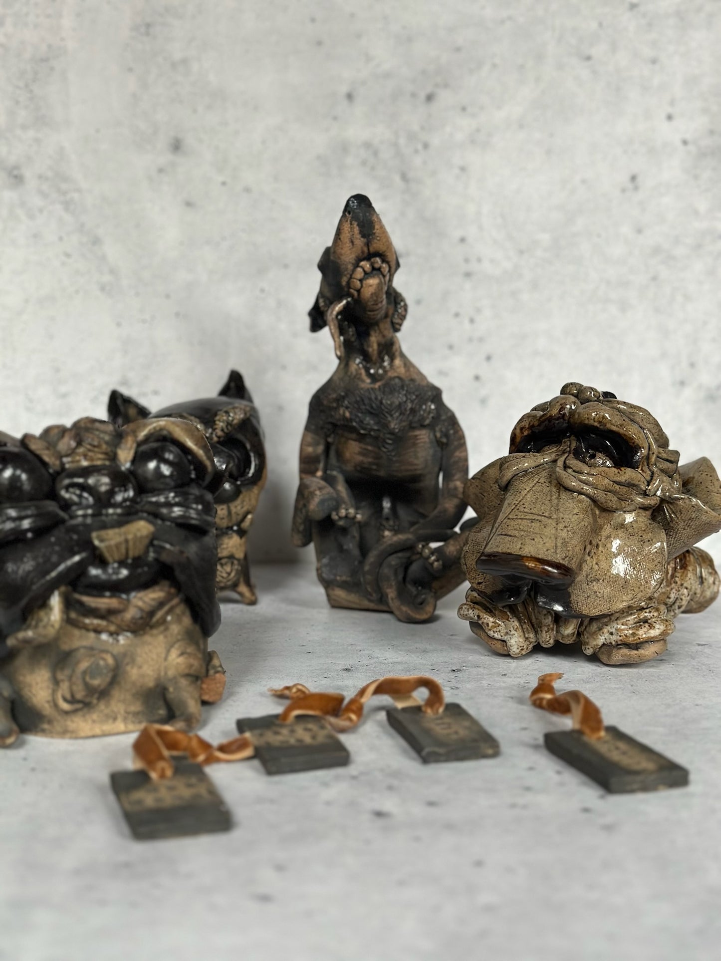 Four small dog figurines on a textured surface