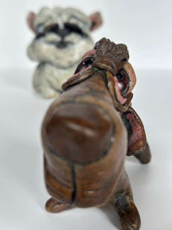 Close-up of a figurine of a dachshund and a bichon frise on a white background