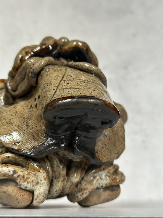 Close-up of a ceramic basset hound sculpture on a white background