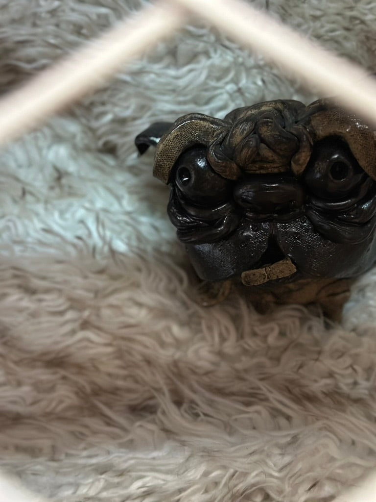 Ceramic pug in crate 