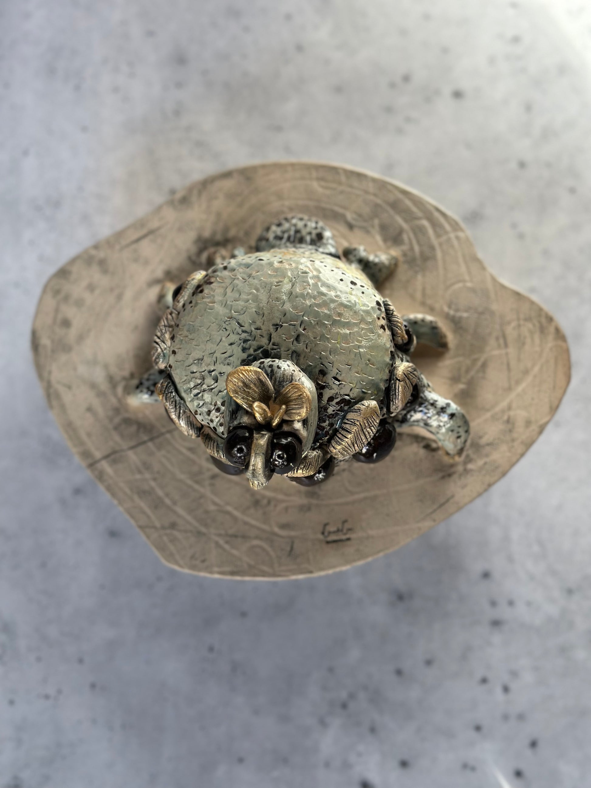 Metallic spider figurine on a textured surface