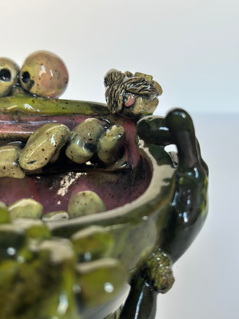Close-up of a ceramic sculpture with detailed texture on a white background