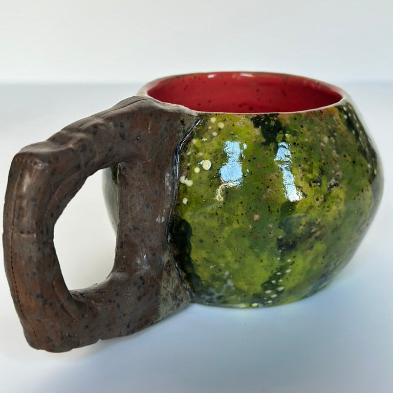 Ceramic mug with a handle on a white background