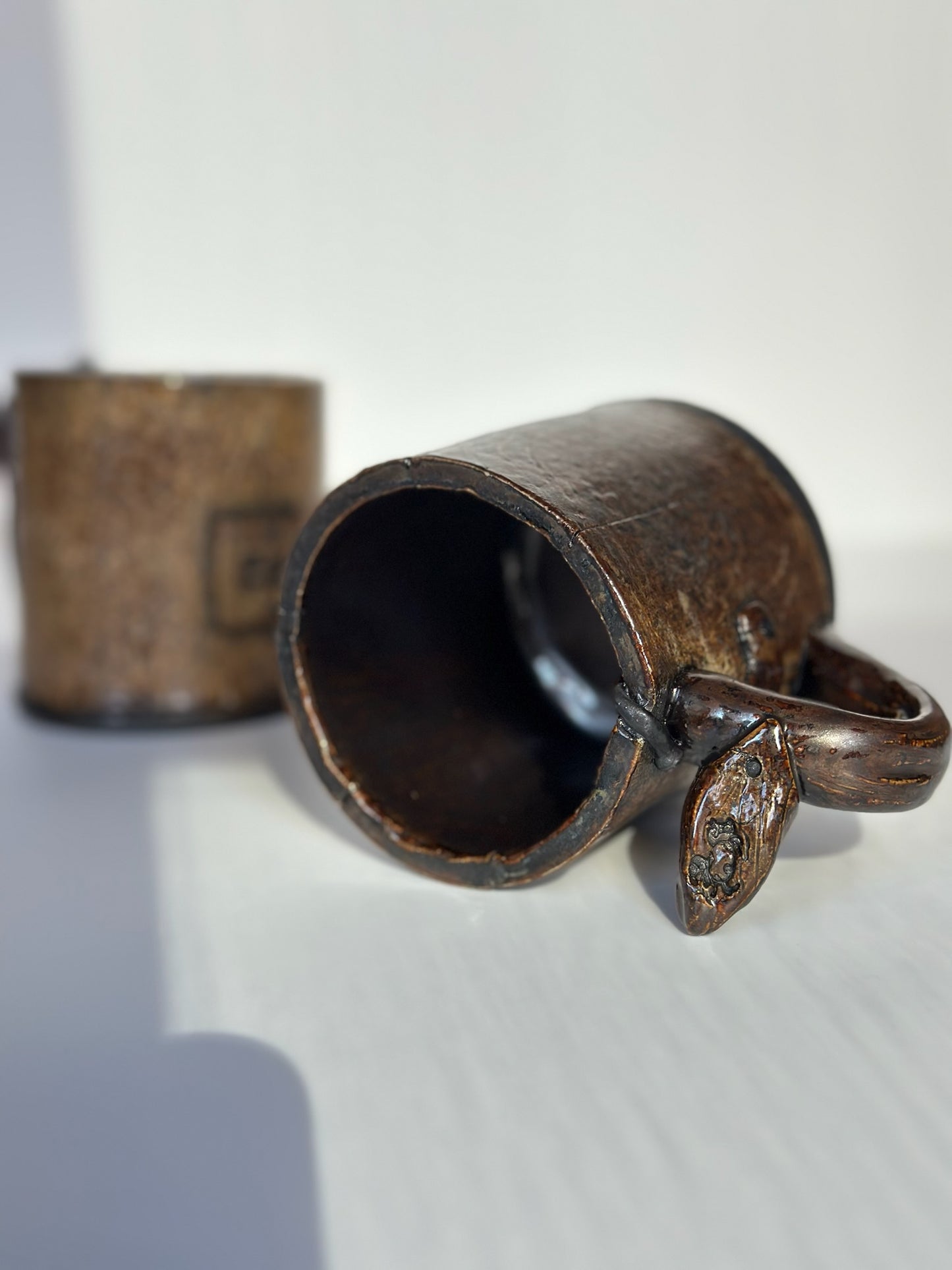 Ceramic mug with handle on a white background