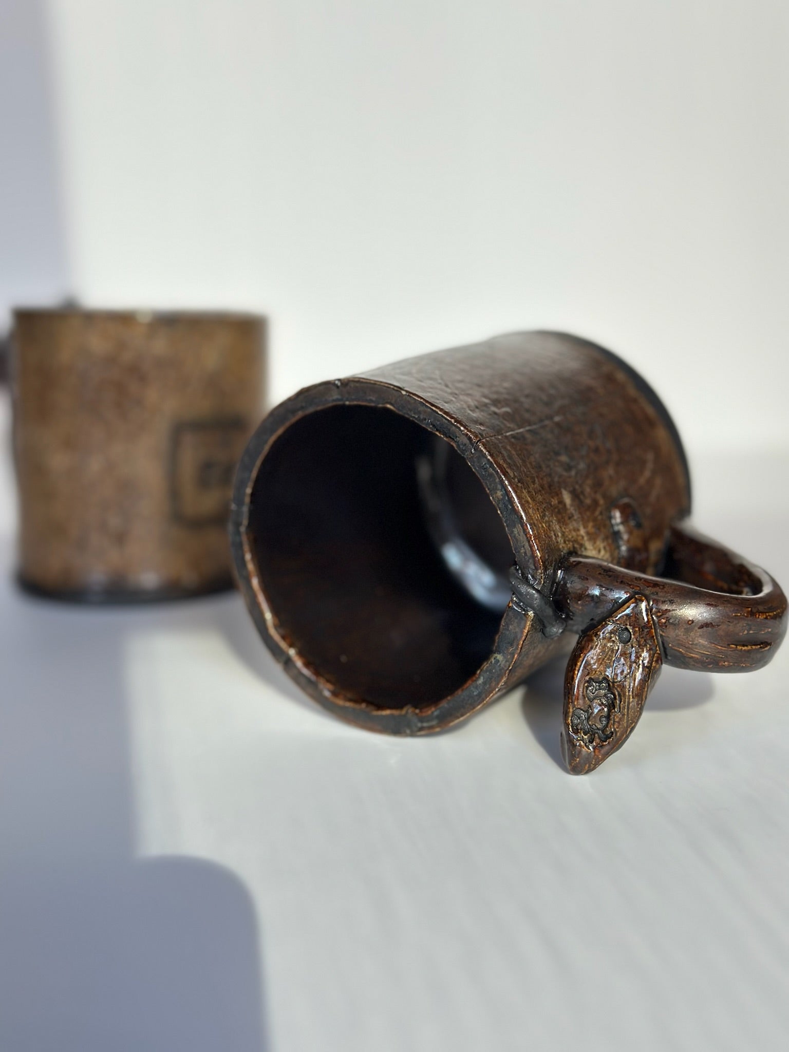 Ceramic mug with handle on a white background