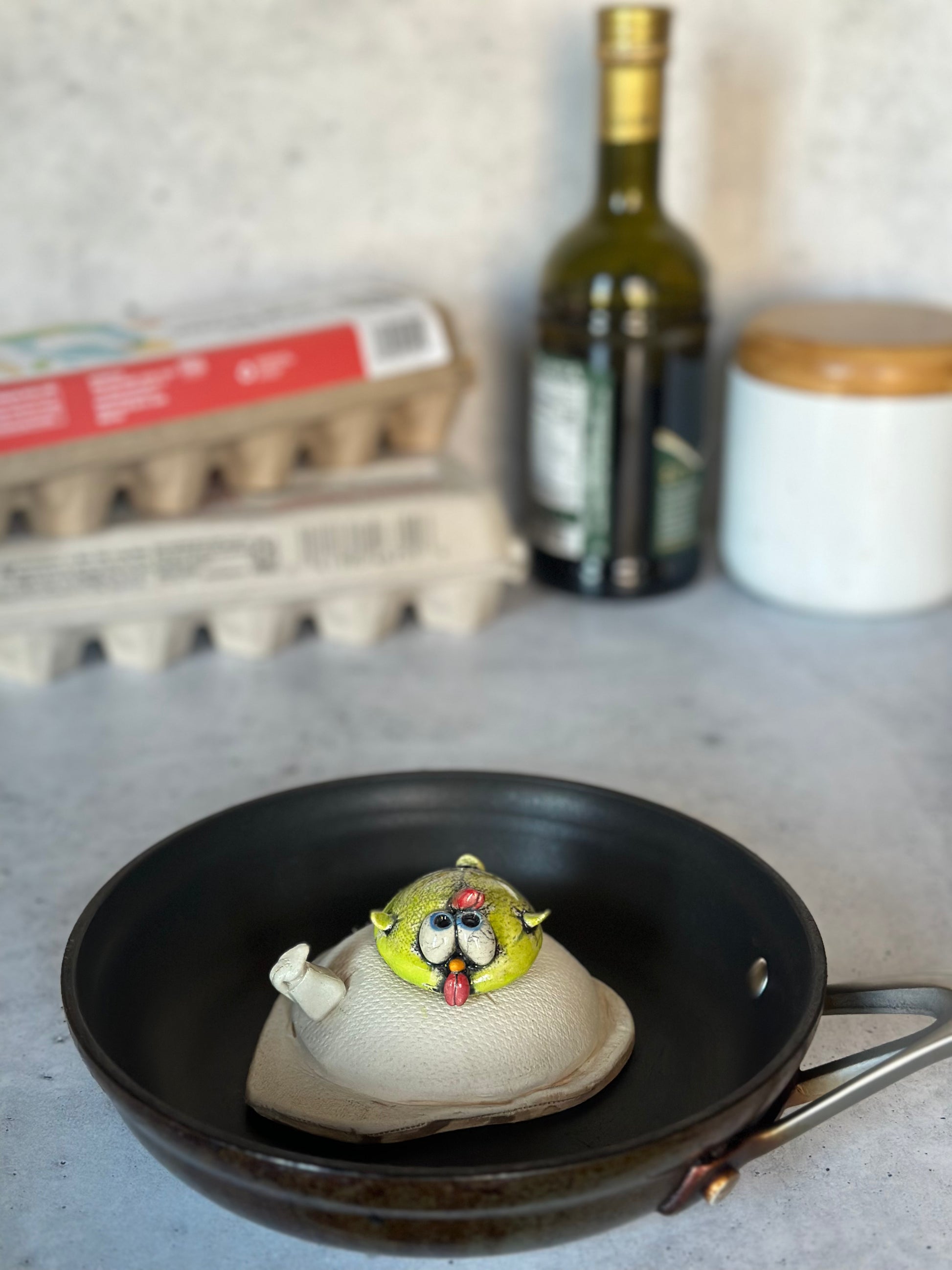 Chick on an egg on a kitchen counter