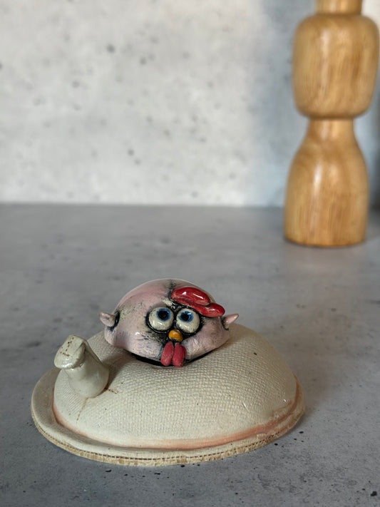 Ceramic chick on a concrete surface