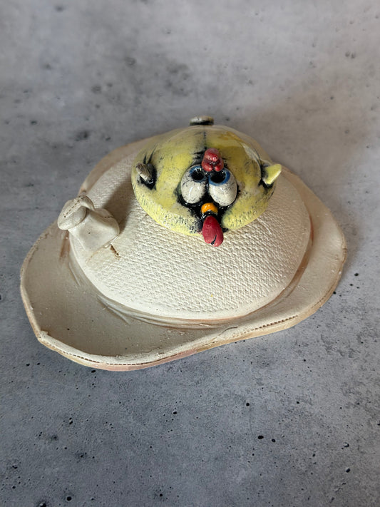 Ceramic chick on egg on a concrete surface