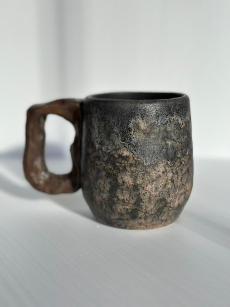 Stoneware mug with a textured surface on a white background