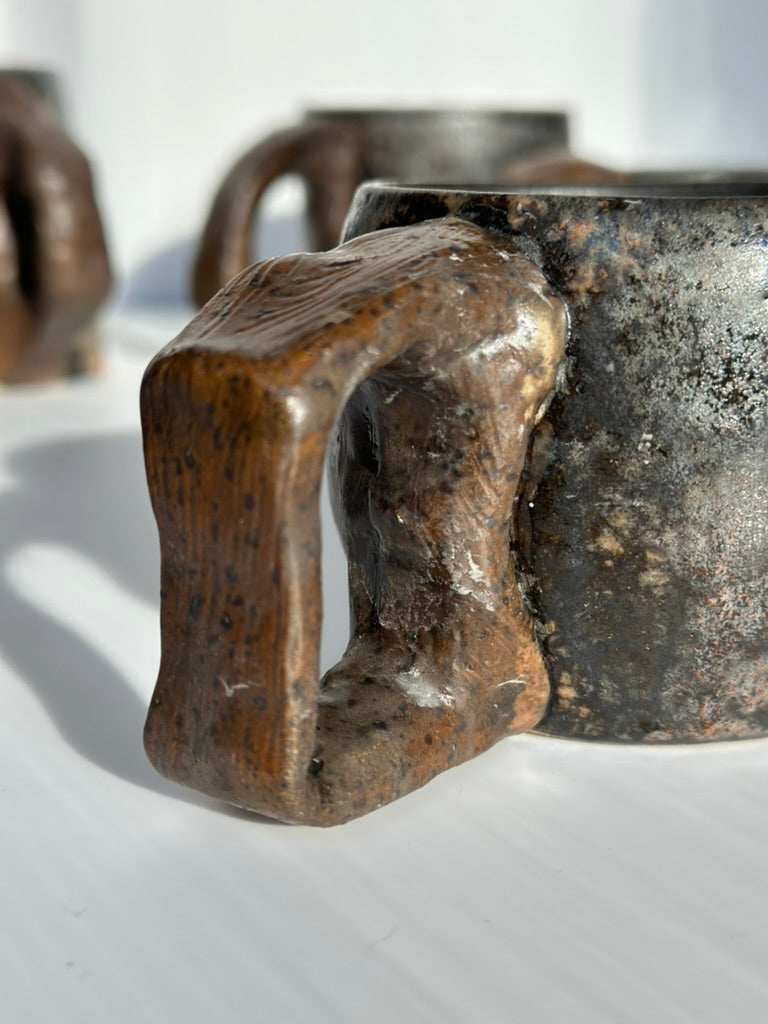 Close-up of a ceramic mug with a handle on a white background