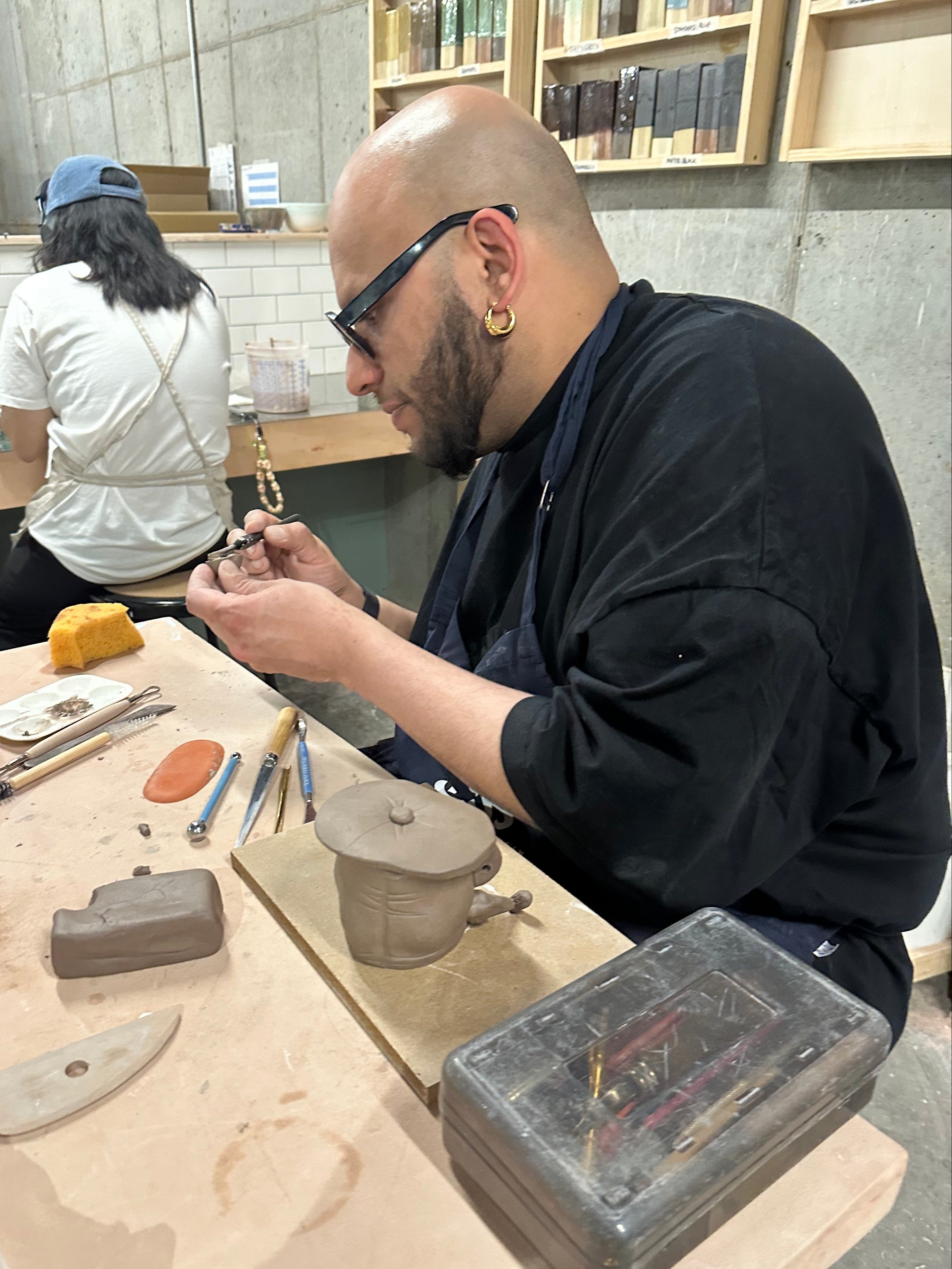 Person working on a project with tools and materials on a table